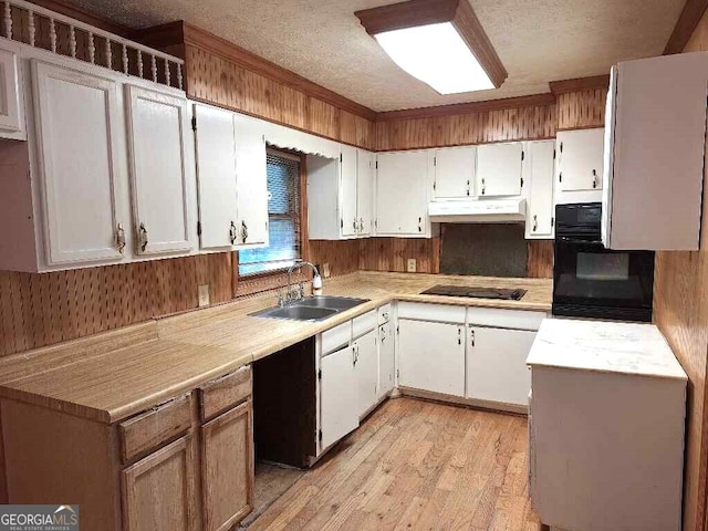 kitchen featuring white cabinets, black appliances, sink, and light wood-type flooring