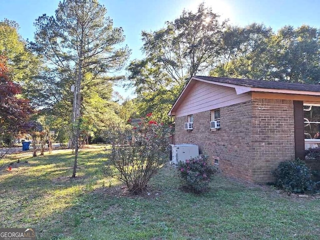 view of property exterior featuring cooling unit and a lawn