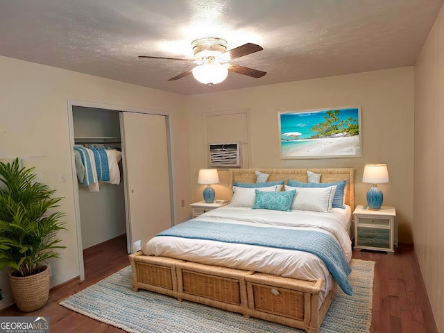 bedroom with a textured ceiling, wood-type flooring, a closet, and ceiling fan