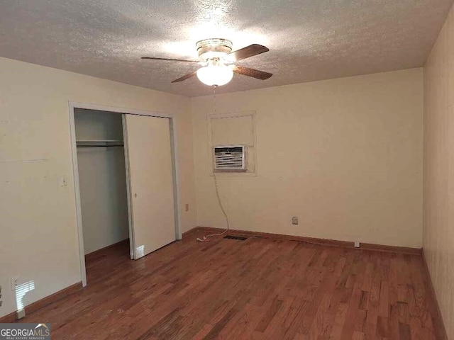 unfurnished bedroom with a closet, ceiling fan, a textured ceiling, and dark hardwood / wood-style floors