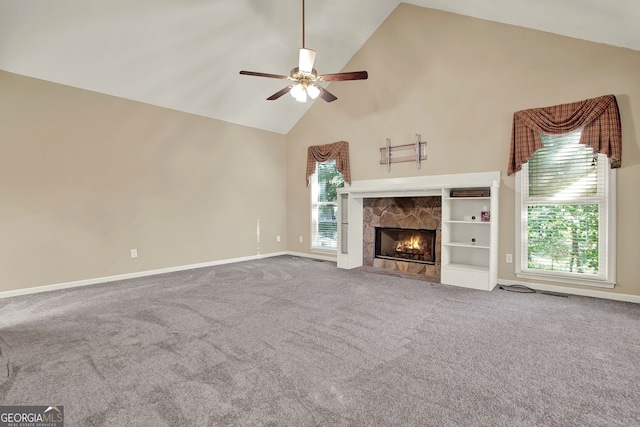 unfurnished living room with ceiling fan, high vaulted ceiling, carpet flooring, and a fireplace