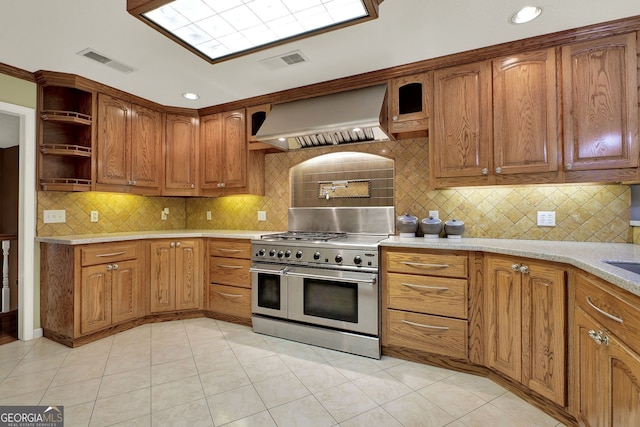 kitchen with light tile patterned floors, premium range hood, backsplash, and double oven range