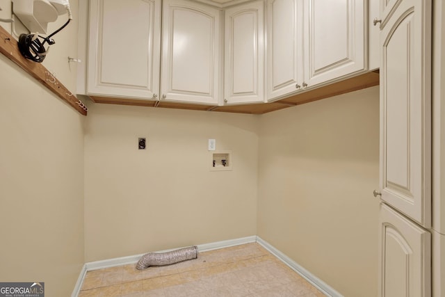 washroom featuring cabinets, light tile patterned flooring, washer hookup, and electric dryer hookup