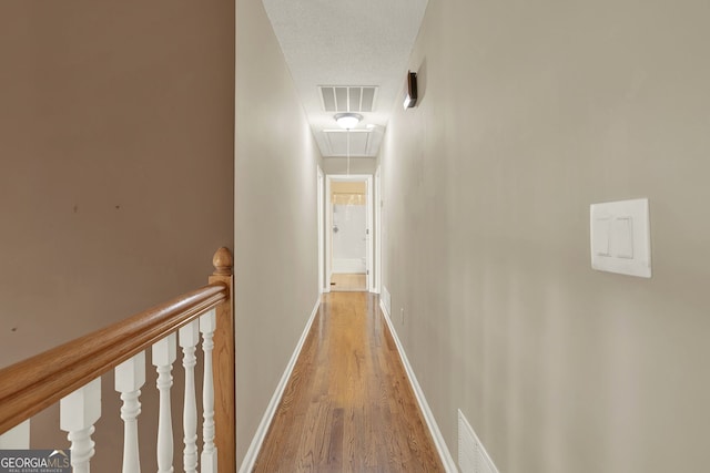 corridor with light hardwood / wood-style flooring