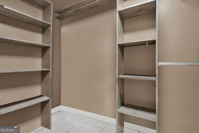 spacious closet featuring light tile patterned flooring