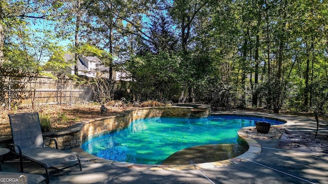 view of swimming pool with an in ground hot tub and a patio