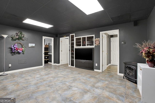 unfurnished living room with a drop ceiling