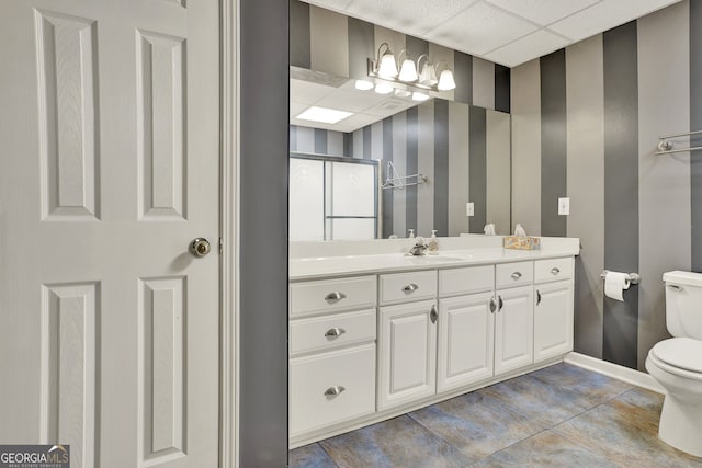 bathroom featuring toilet, a paneled ceiling, vanity, and tile patterned floors