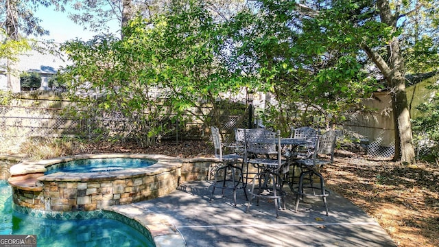 view of patio with an in ground hot tub