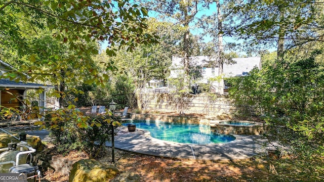 view of pool with an in ground hot tub and a patio