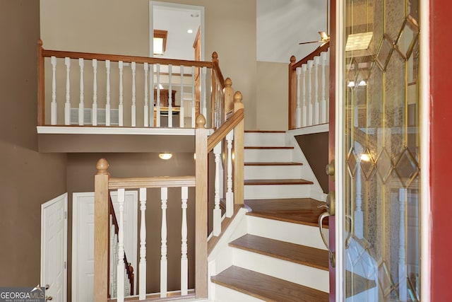 staircase with ceiling fan