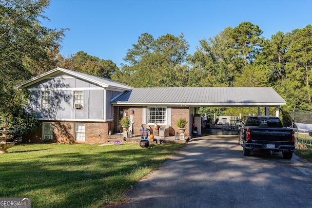 split level home featuring a front lawn and a carport