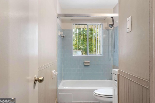 bathroom featuring toilet and tiled shower / bath combo