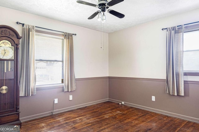 unfurnished room with a textured ceiling, ceiling fan, and dark hardwood / wood-style flooring