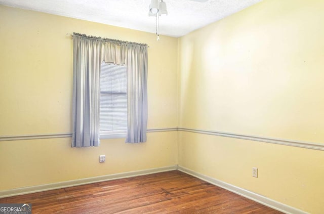 empty room featuring hardwood / wood-style floors, a textured ceiling, and ceiling fan