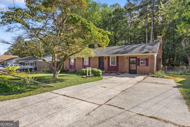 ranch-style home with a front lawn