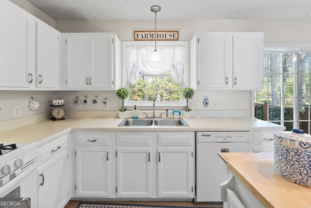 kitchen with white cabinets, hanging light fixtures, and white appliances