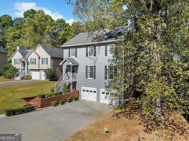 view of front of property featuring a garage and a front lawn