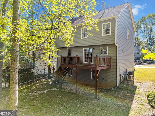 back of house featuring a yard, a deck, and cooling unit