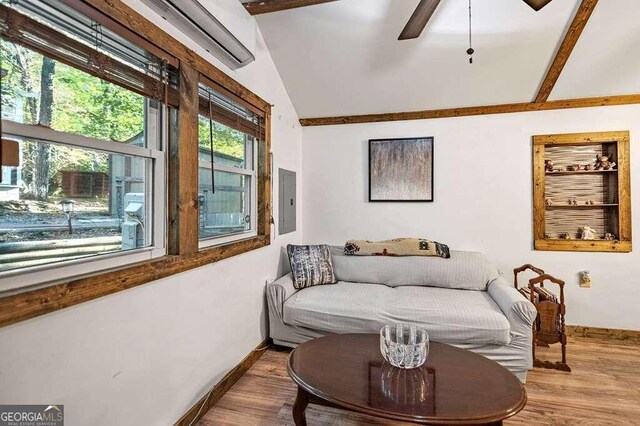 sitting room featuring light hardwood / wood-style flooring, electric panel, lofted ceiling, and ceiling fan