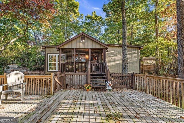 wooden terrace featuring a sunroom