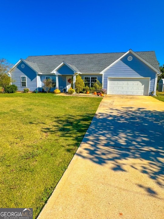 ranch-style house featuring a garage and a front lawn