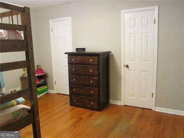 bedroom with wood-type flooring