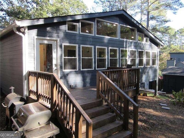 rear view of house with a wooden deck