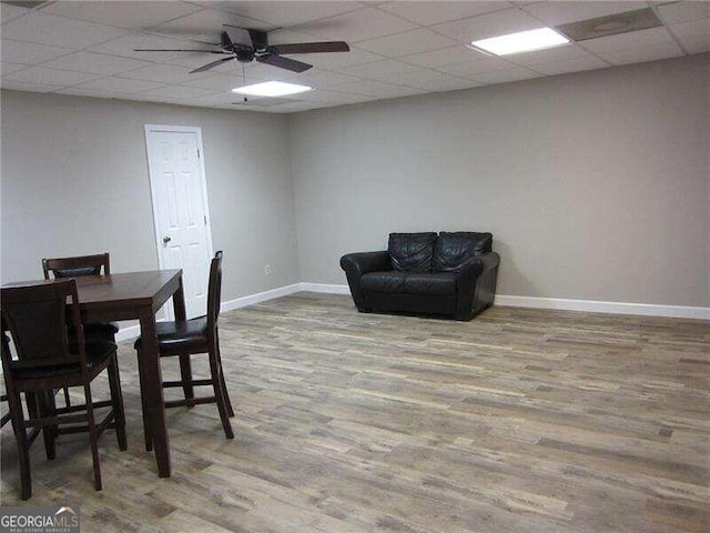 dining space featuring a paneled ceiling, light wood-type flooring, and ceiling fan