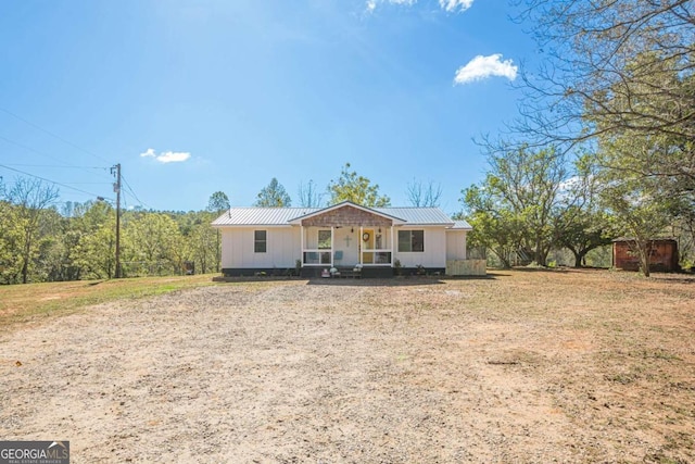 ranch-style house with a front yard and a porch