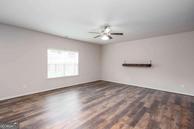 unfurnished room featuring dark wood-type flooring and ceiling fan