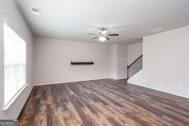 unfurnished living room with dark wood-type flooring and ceiling fan