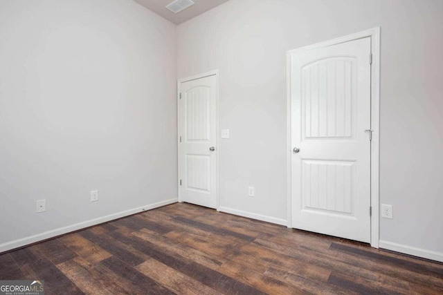 empty room featuring dark hardwood / wood-style floors