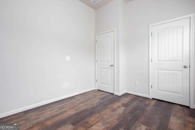 unfurnished bedroom with dark hardwood / wood-style floors