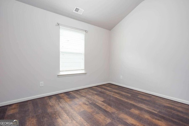 unfurnished room with dark hardwood / wood-style flooring and plenty of natural light