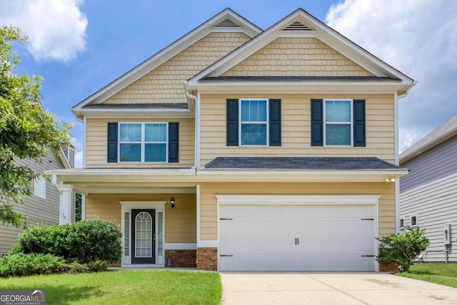 craftsman-style house with a garage and a front lawn