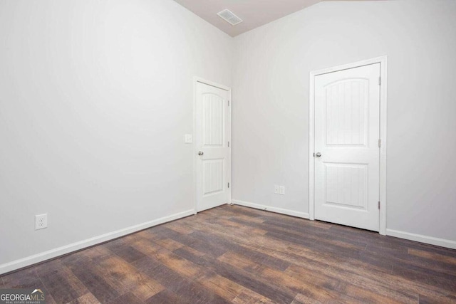 empty room featuring dark hardwood / wood-style flooring