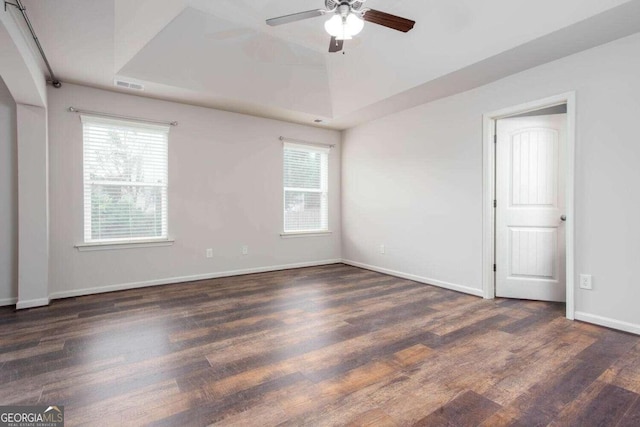 spare room with ceiling fan, dark hardwood / wood-style floors, and plenty of natural light