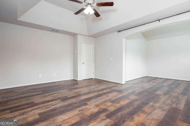 spare room with dark wood-type flooring and ceiling fan