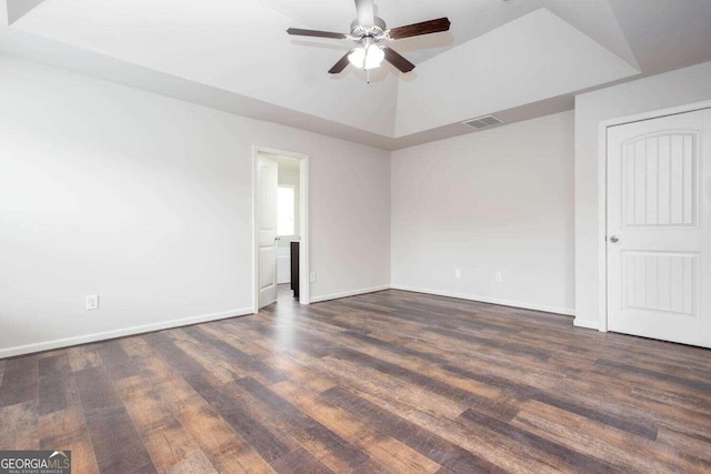 empty room with dark hardwood / wood-style flooring and ceiling fan