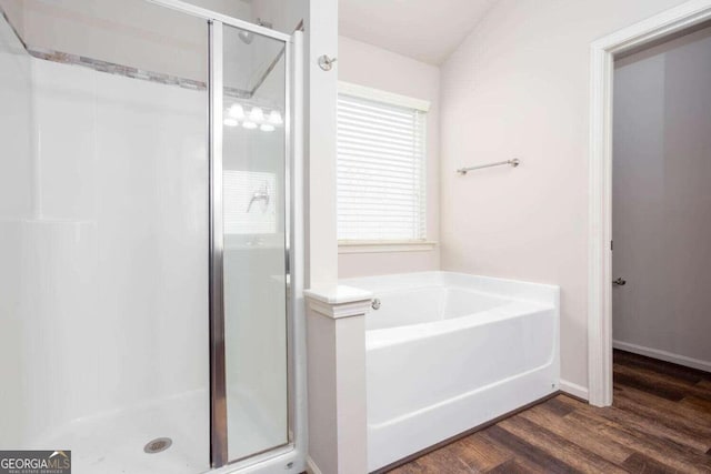 bathroom featuring hardwood / wood-style flooring and separate shower and tub