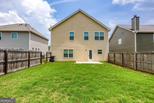 rear view of house with a patio and a lawn