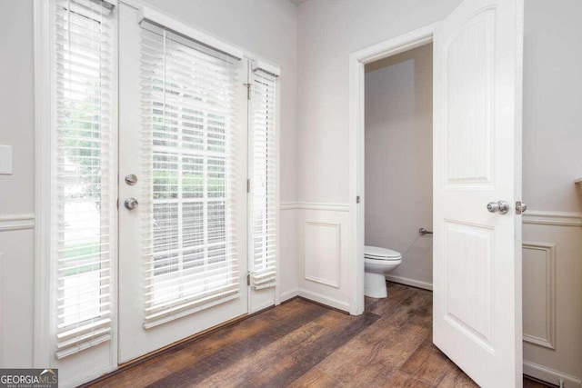 bathroom with toilet and hardwood / wood-style floors