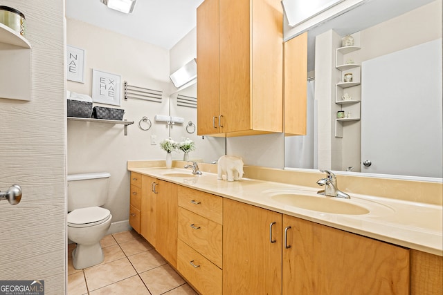 bathroom with vanity, tile patterned floors, and toilet