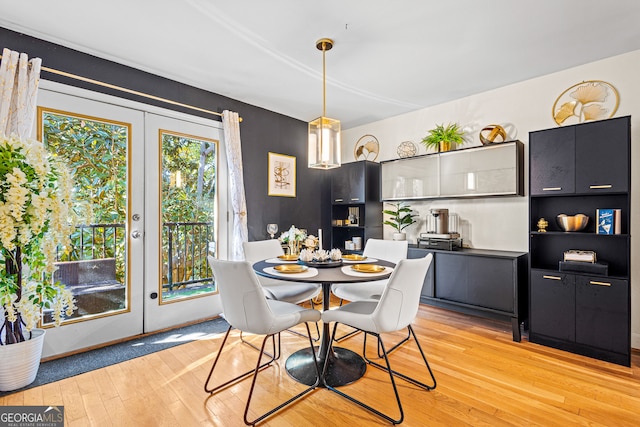 dining space with light hardwood / wood-style flooring and french doors