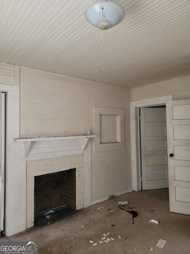 unfurnished living room featuring a brick fireplace