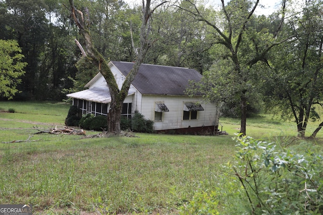 view of property exterior featuring a lawn