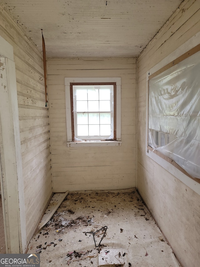 unfurnished room with wooden walls