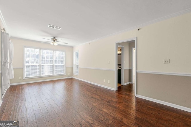 empty room with ornamental molding, dark hardwood / wood-style floors, and ceiling fan