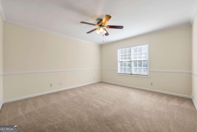 carpeted spare room featuring crown molding and ceiling fan